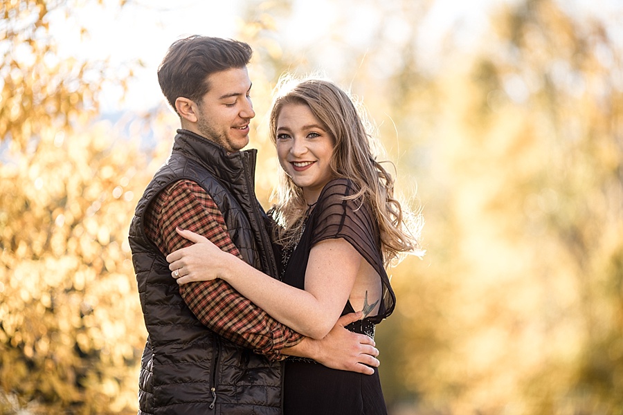 engaged couple poses with stunning fall foliage  in breckenridge colorado for engagement photos 