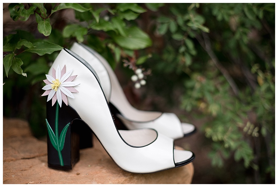 bride's wedding ceremony shoes with daisy on the heels