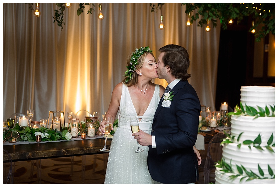 bride and groom kiss and drink champagne at their ritz Carlton bachelor gulch wedding