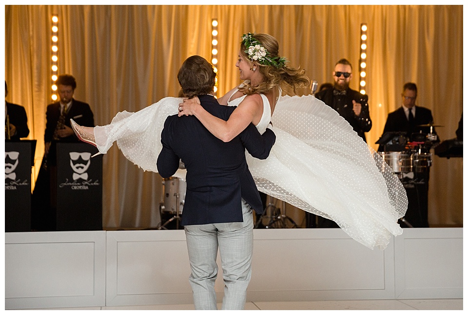 groom picks up bride and sweeps her off her feet