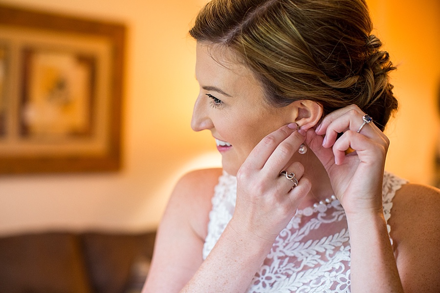bride putting her earrings on at keystone resort and spa