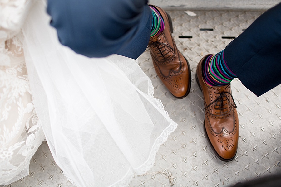 detail of bride's dress and groom's fun colorful socks in colorado 