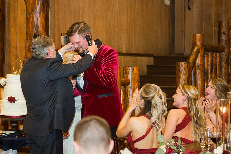 father of the bride gives groom bear claw necklace gift during toasts 