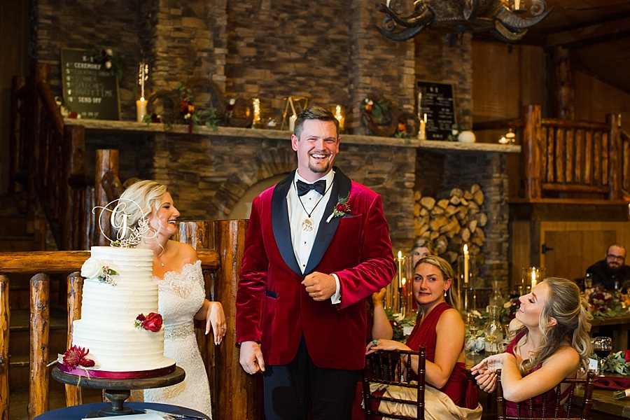 groom smiling with gift from father of the bride, a bear claw necklace 