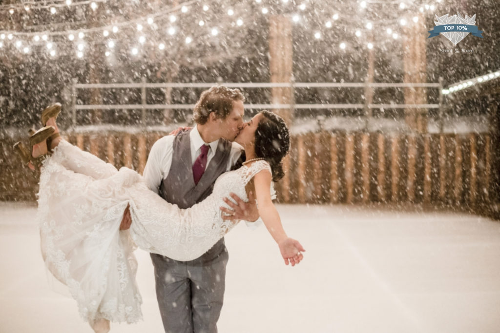 Snow falls on the courtyard at Spruce Mountain Winter Wedding