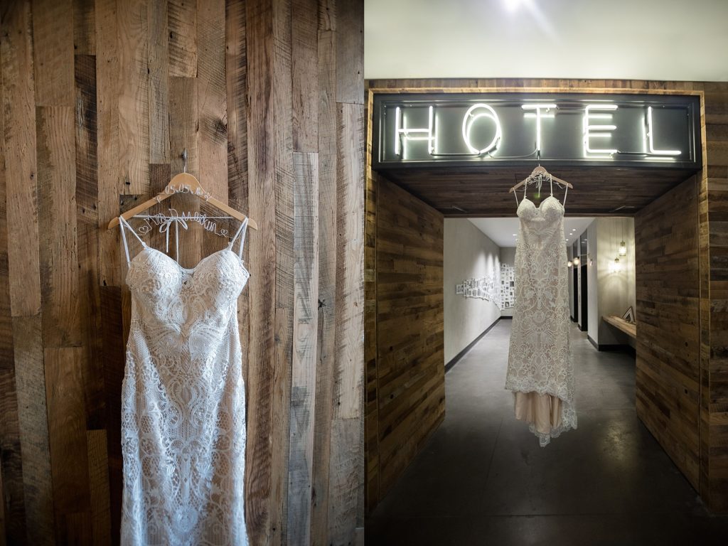 photo of lace wedding dress hung up near wood wall and neon sign at the maven dairy block denver