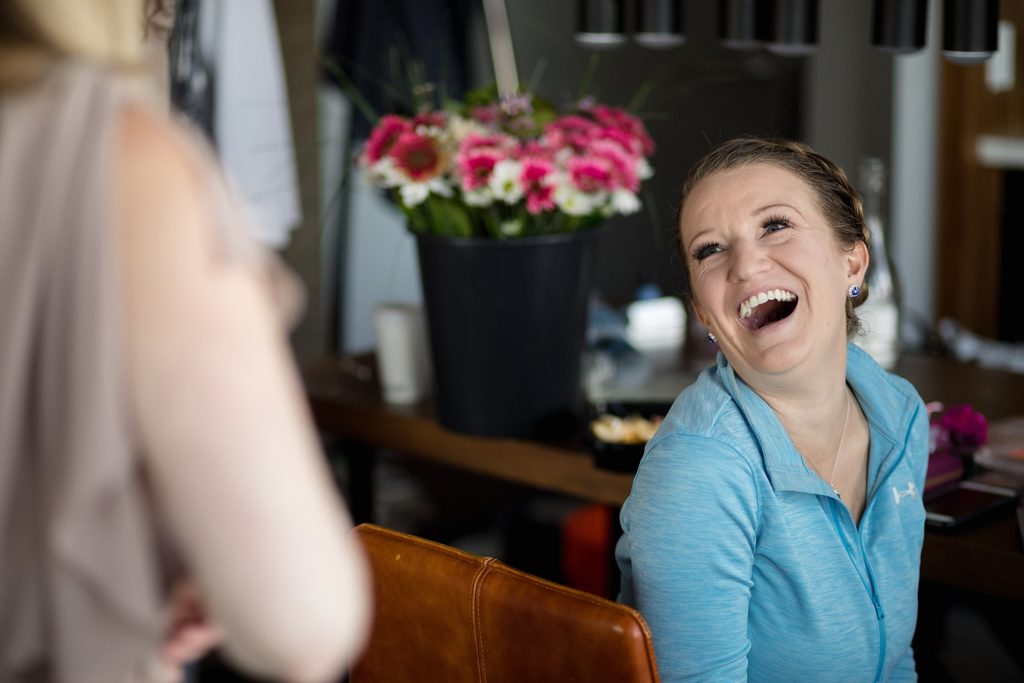 bride laughs while getting ready for her red rocks denver wedding