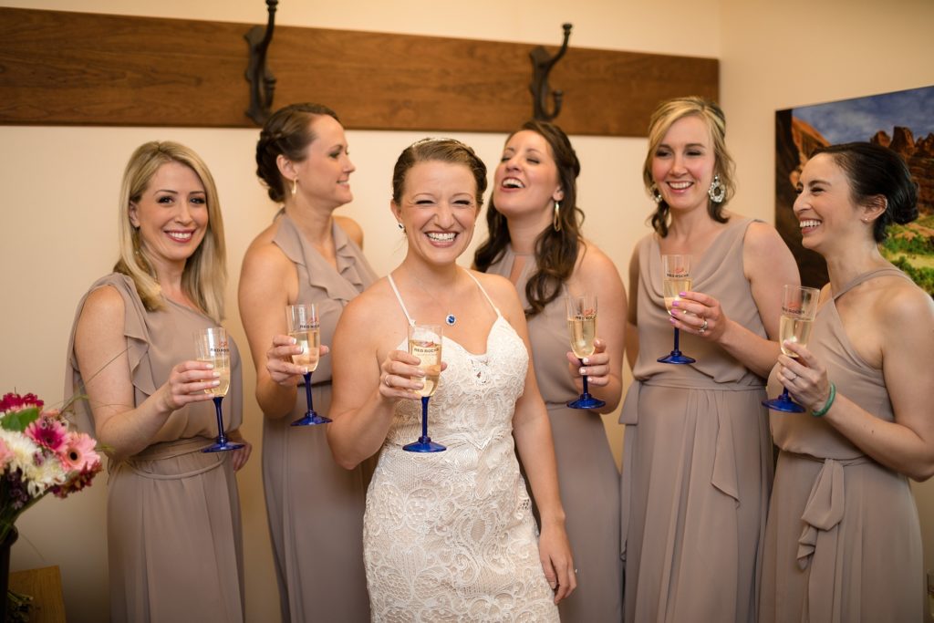 bride and her bridesmaids toast with champagne before the red rocks trading post wedding 