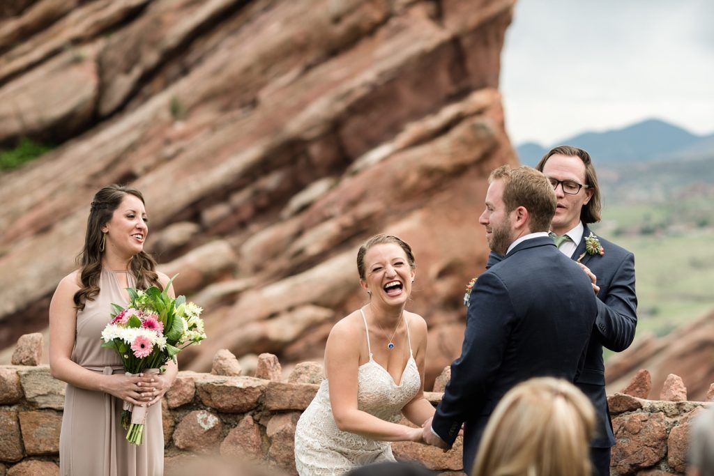 bride laughing at wedding ceremony at red rocks trading post 