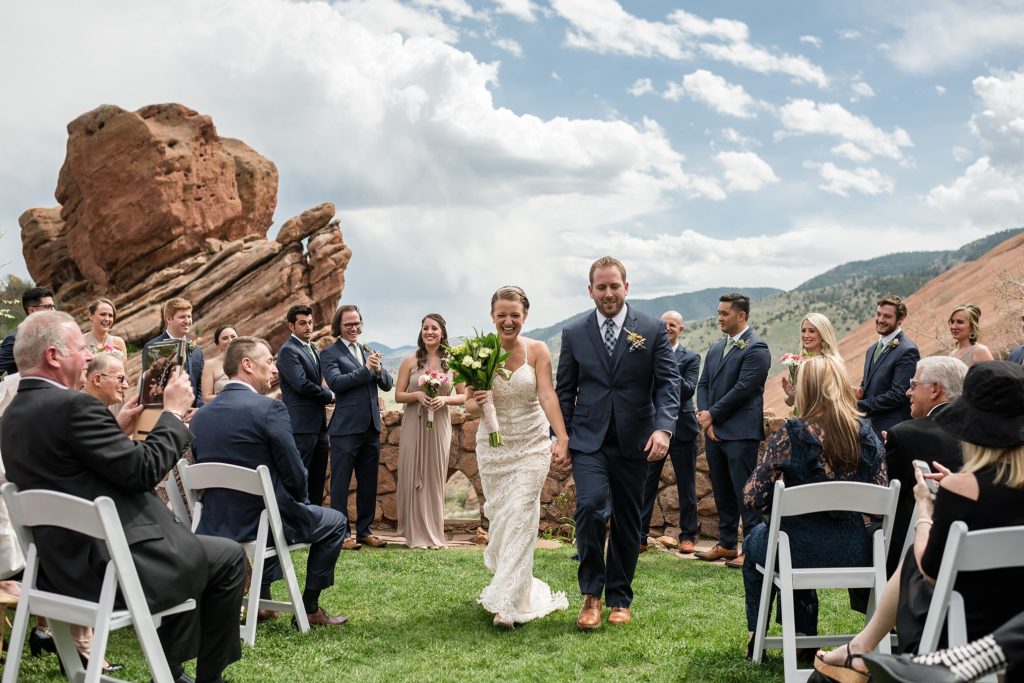 bride and groom walk back down the aisle after their wedding ceremony at red rocks trading post 