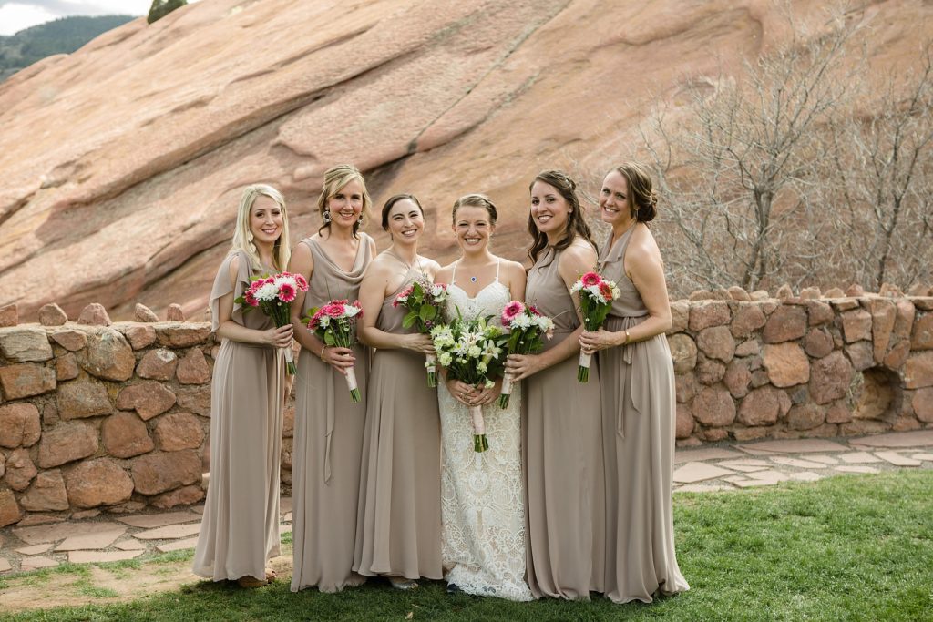 bride and her bridesmaids pose at red rocks park 