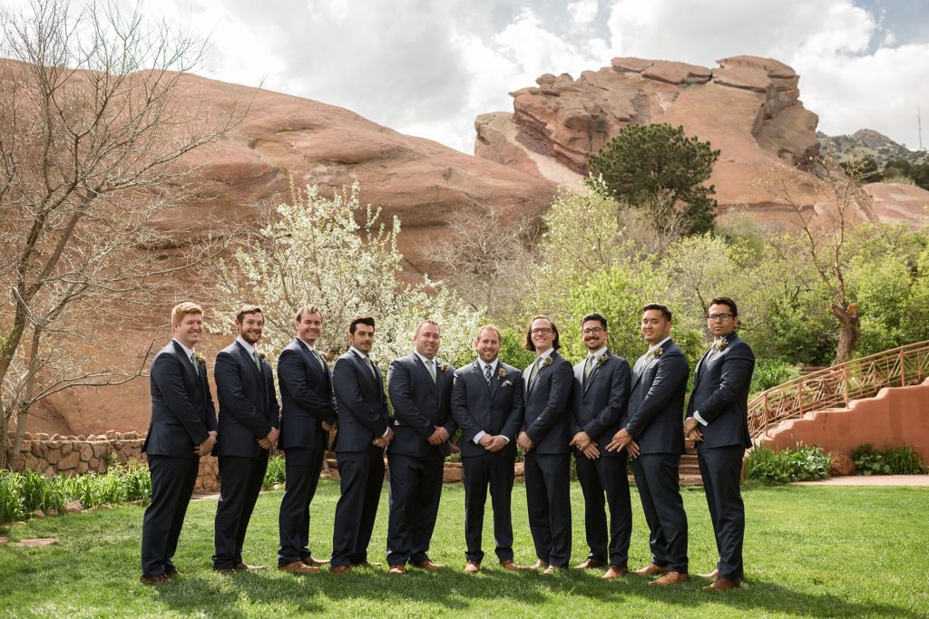 groom poses with his groomsmen at red rocks park