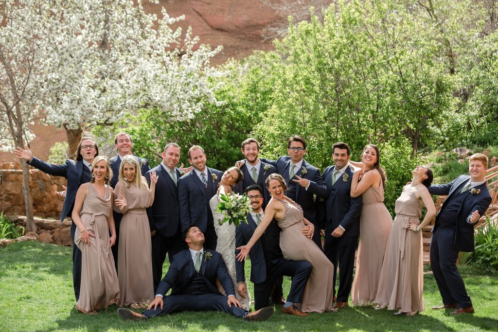 bride and groom pose with their bridal party 