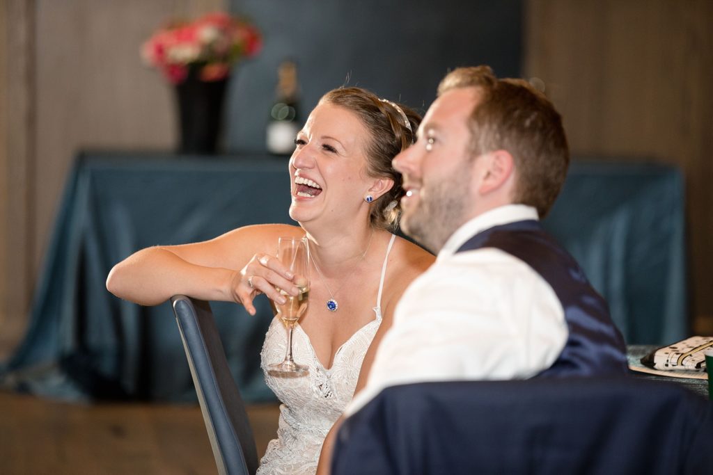bride and groom laugh during wedding toasts in denver colorado 