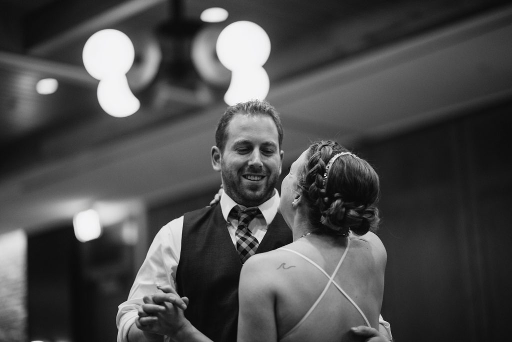 groom looks at bride during first dance as husband and wife