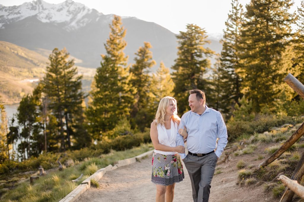 engaged couple laughing while walking at sapphire point in breckenridge