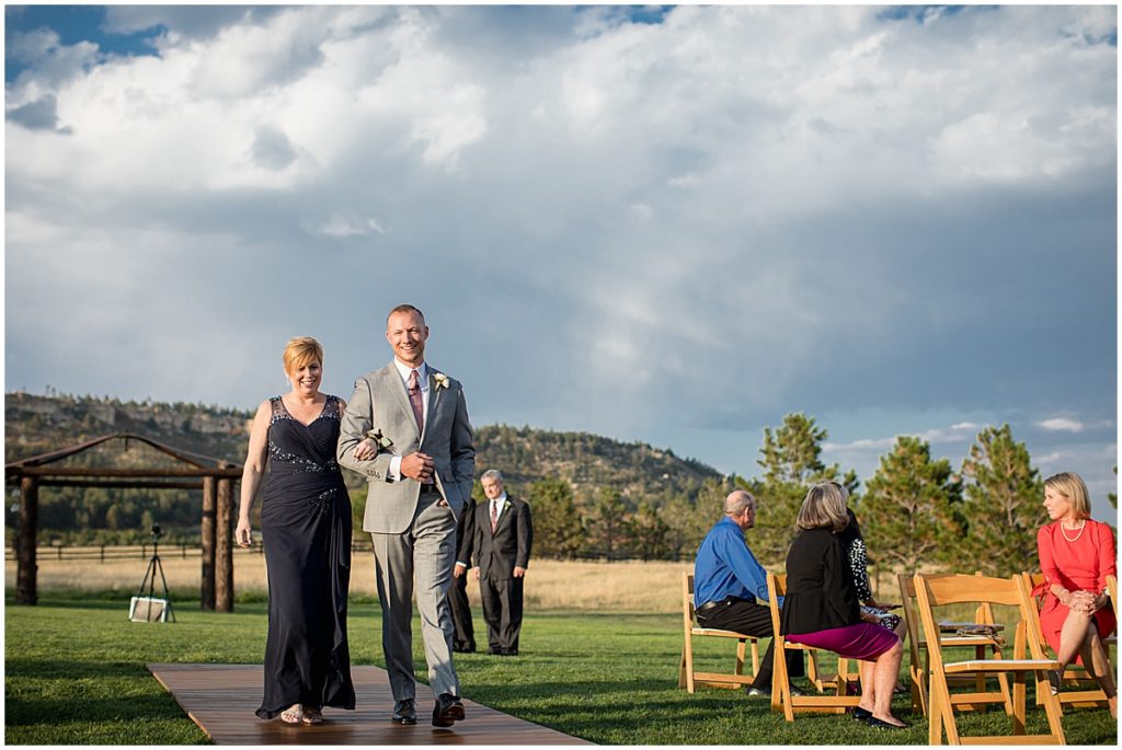 Groom and mom walking down the aisle at Spruce Mountain Ranch