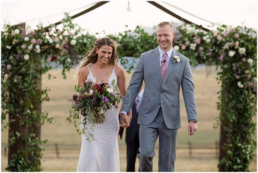 Just married with Floral Arch by The Perfect Petal at Spruce Mountain Ranch