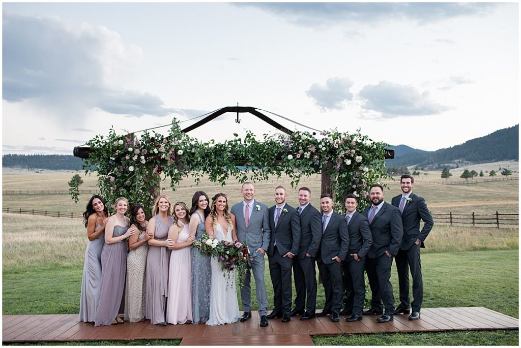 Bridal party photo with Floral Arch by The Perfect Petal at Spruce Mountain Ranch Trey's Vista in the Fall