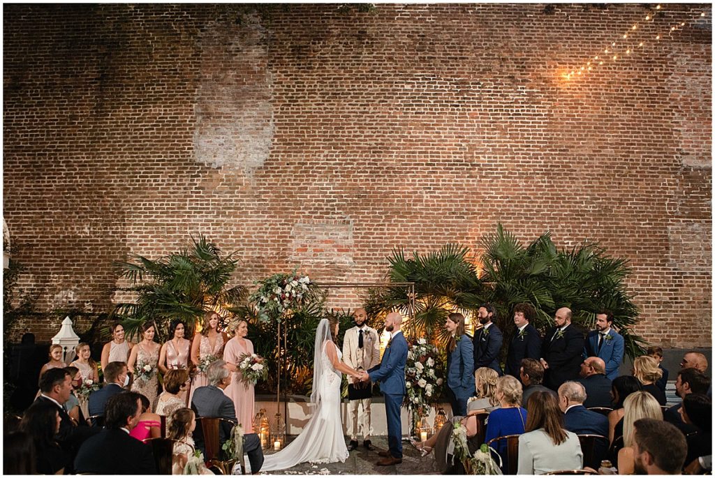 Wedding ceremony at Margaret Place Hotel under arch with floral design by The Plant Gallery
