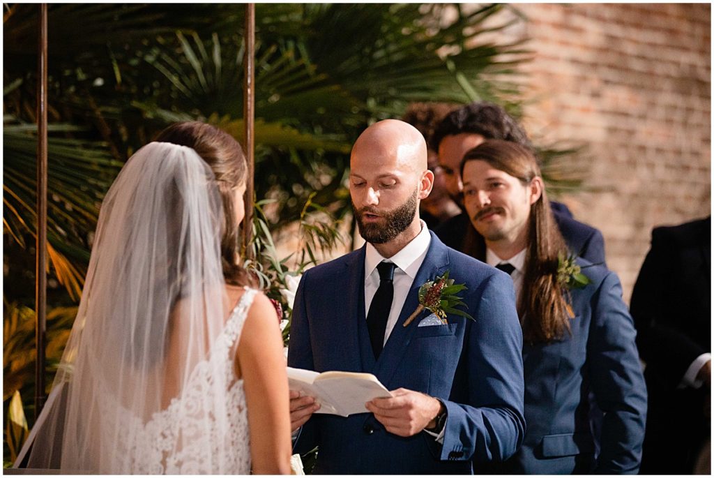 Groom reading vows during wedding ceremony at Margaret Place Hotel in New Orleans