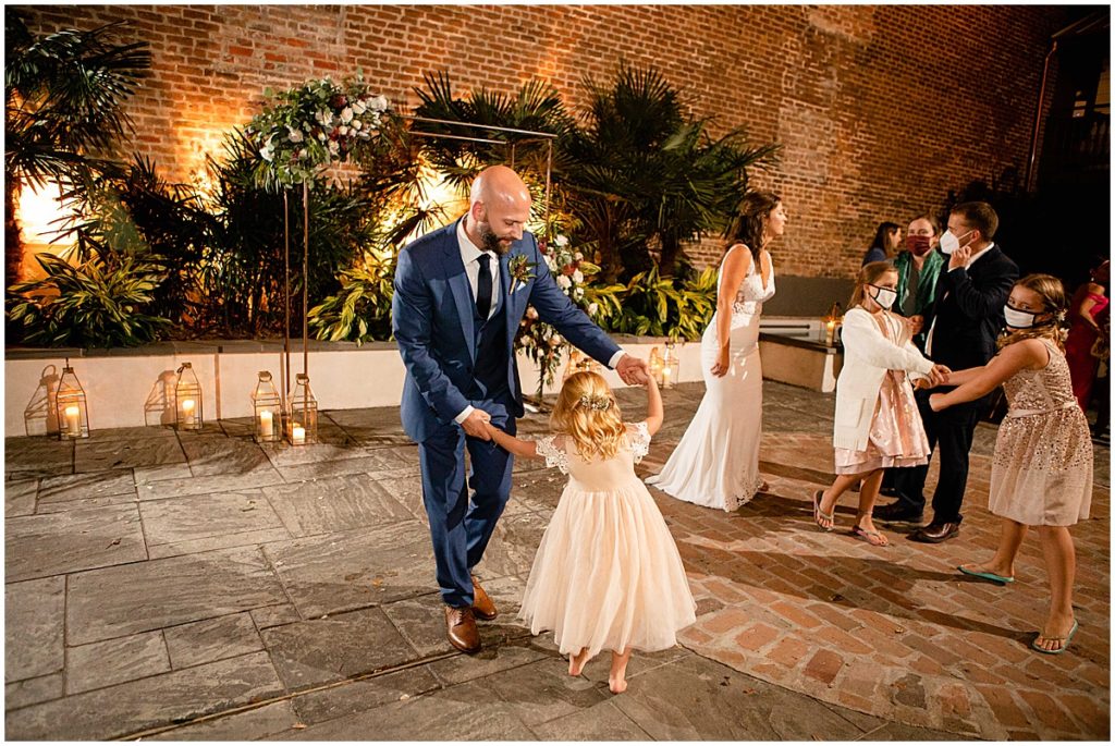 Groom and flower girl dance at Margaret Place in New Orleans