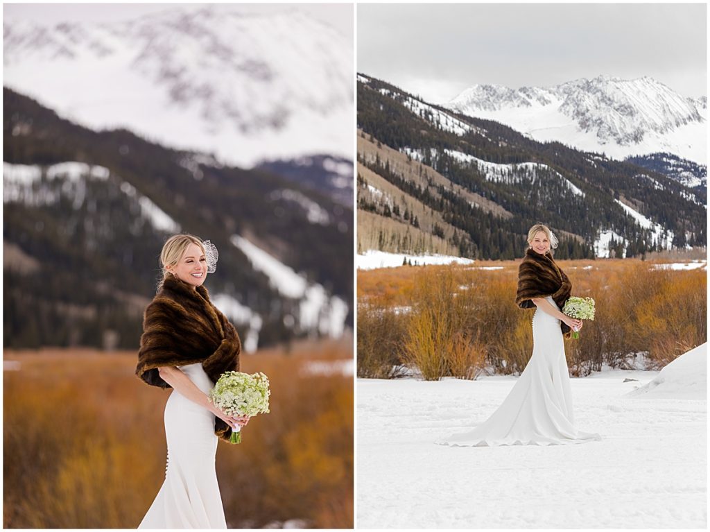 Bride wearing dress in snow from Jenny Yoo outside The Pine Creek Cookhouse in Aspen holding bouquet designed by Aspen Branch Design for winter wedding.