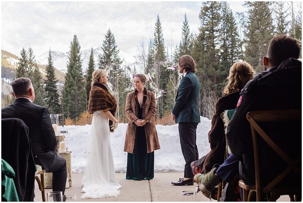 Winter wedding ceremony with snow at The Pine Creek Cookhouse in Aspen