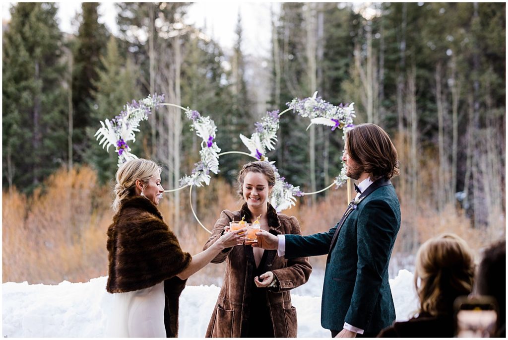 Winter wedding ceremony at The Pine Creek Cookhouse in Aspen with floral decor by Aspen Branch Design