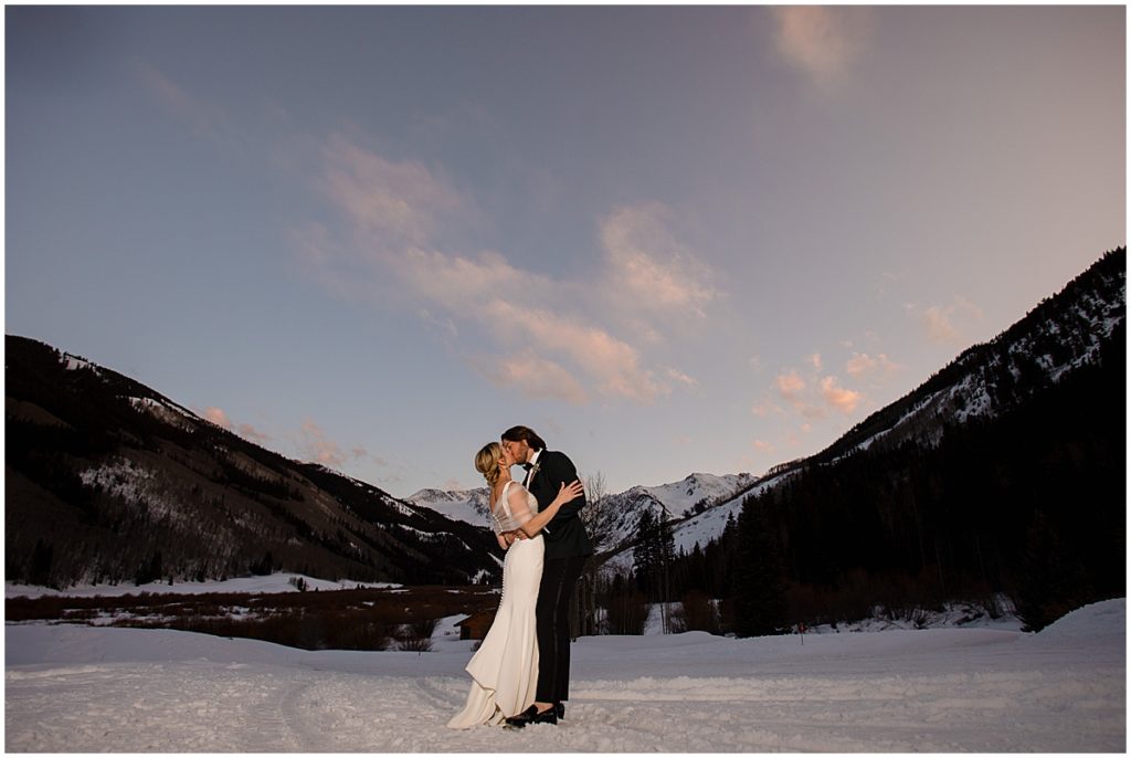 Bride and groom outside in the snow at The Pine Creek Cookhouse in Aspen for winter wedding.