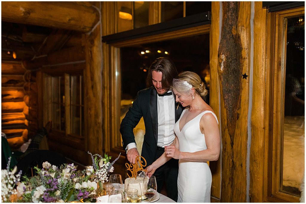 Bride and groom cutting their wedding cake at The Pine Creek Cookhouse in Aspen