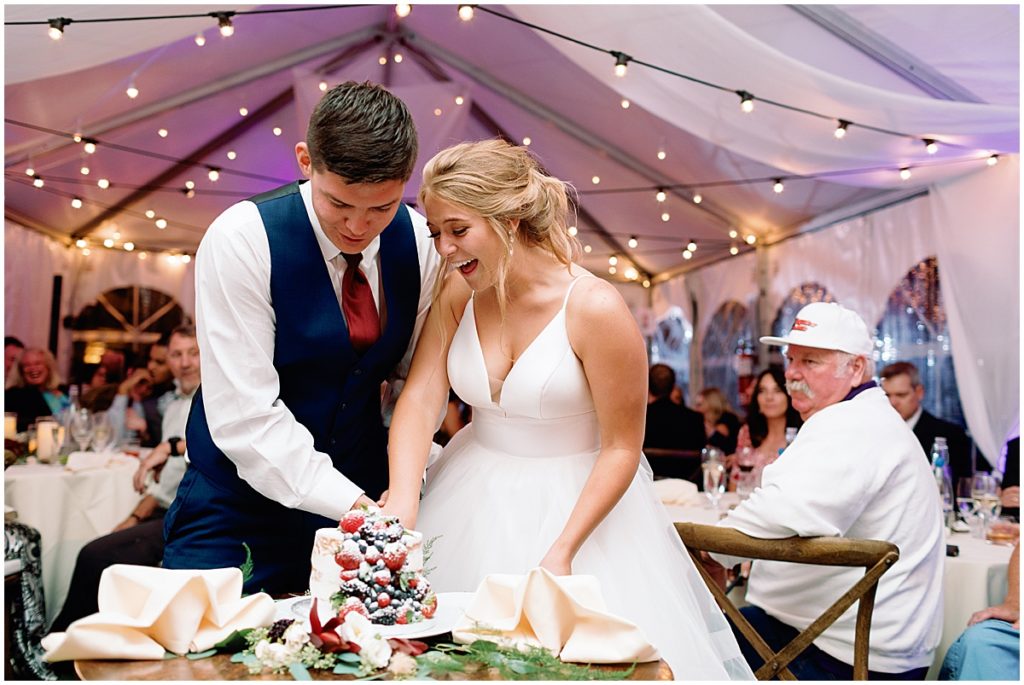 Bride and groom cutting wedding cake at Ski Tip Lodge