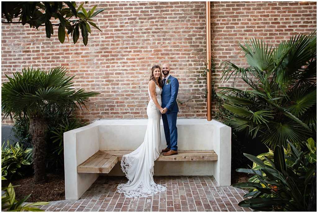 Bench photo of bride and groom at Margaret Place in New Orleans