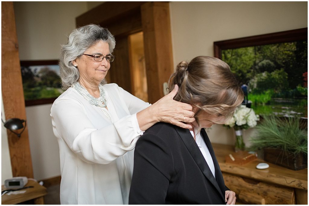 Mother helping daughter get ready for LGBTQ elopement ceremony at Sapphire Point Breckenridge.
