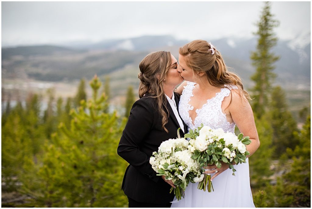 Brides outside holding bouquets designed by Indigo Flowers before elopement ceremony at Sapphire Point in Breckenridge.