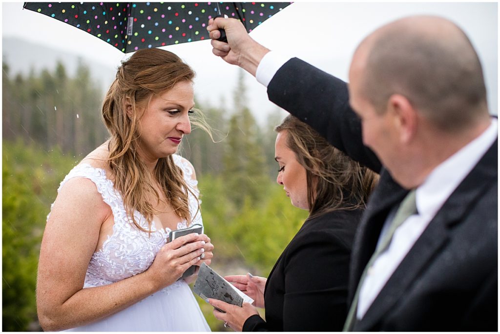 Brides exchanging vows during LGBTQ elopement ceremony at Sapphire Point in Breckenridge.