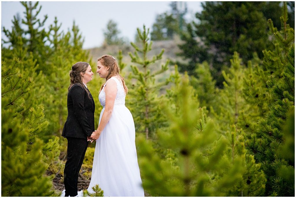 Brides embrace outside during elopement at Sapphire Point in Breckenridge.