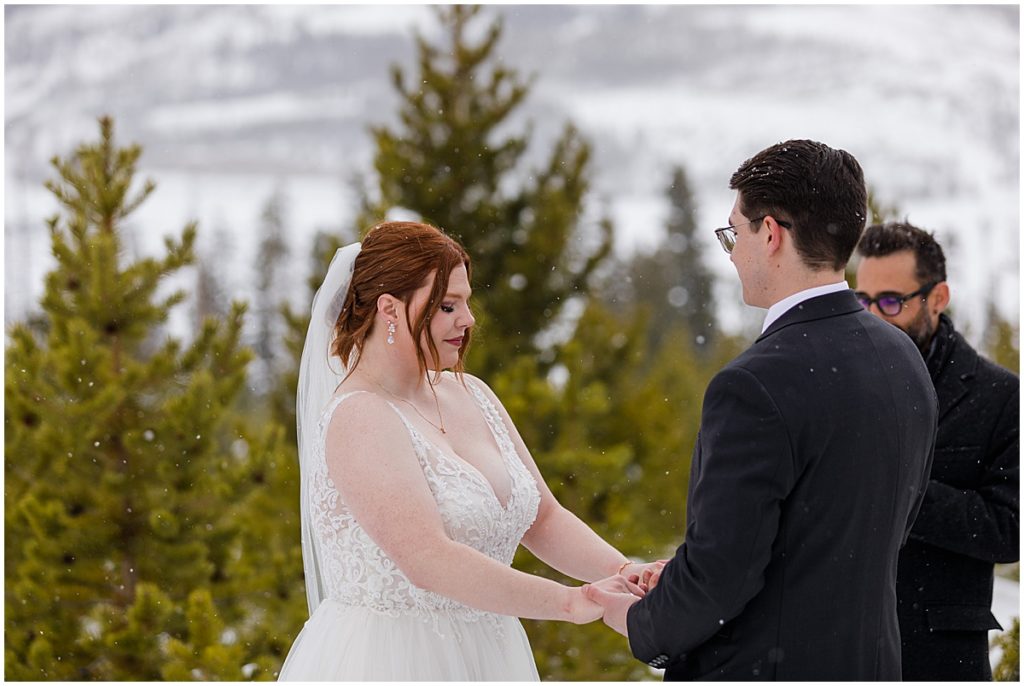 Bride and groom at Sapphire Point in Breckenridge for micro wedding ceremony.  Bride is wearing a dress from Champagne and Lace Bridal.