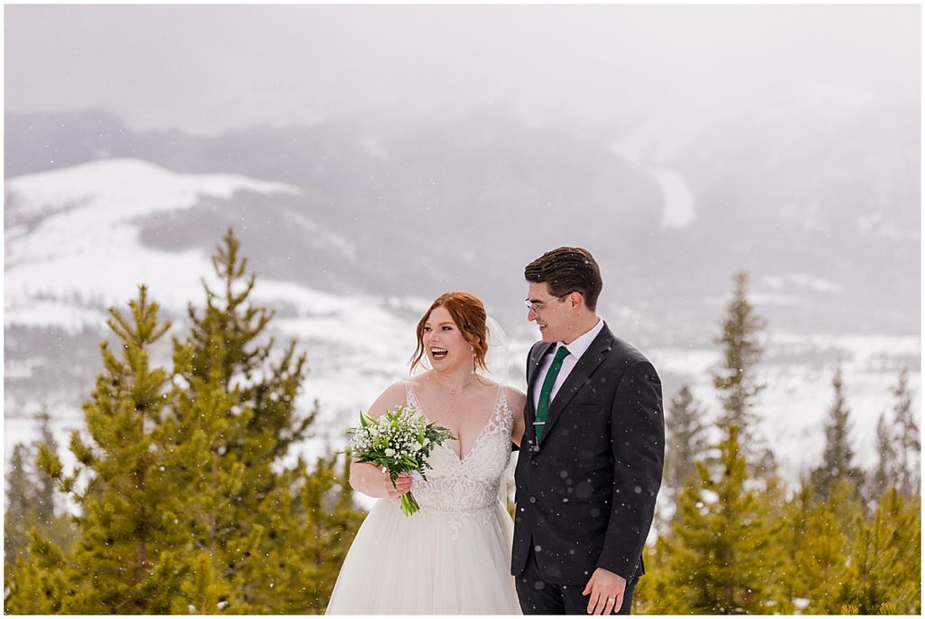 Bride and groom at Sapphire Point in Breckenridge for a micro wedding ceremony.  Bride is wearing a dress from Champagne and Lace Bridal.  Bride is holding bouquet designed by Garden of Eden Flowers and Gifts.
