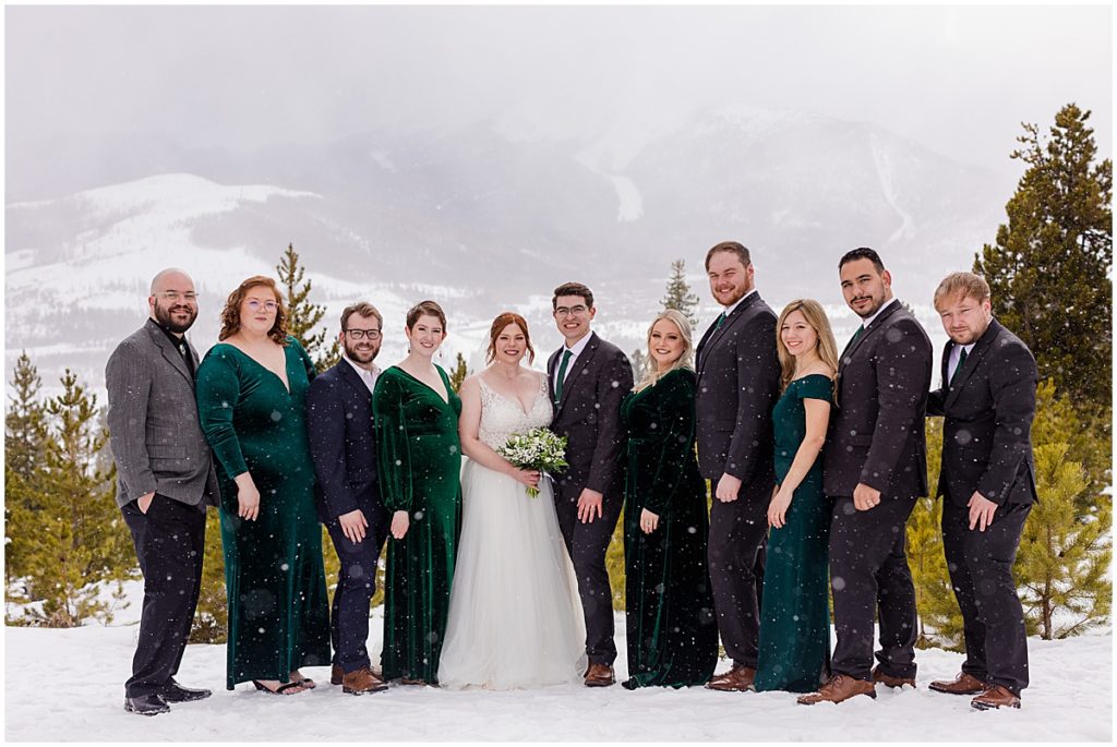 Bridal party at Sapphire Point in Breckenridge for a micro wedding ceremony.  Bride is wearing a dress from Champagne and Lace Bridal.  Bride is holding a bouquet designed by Garden of Eden Flowers and Gifts.