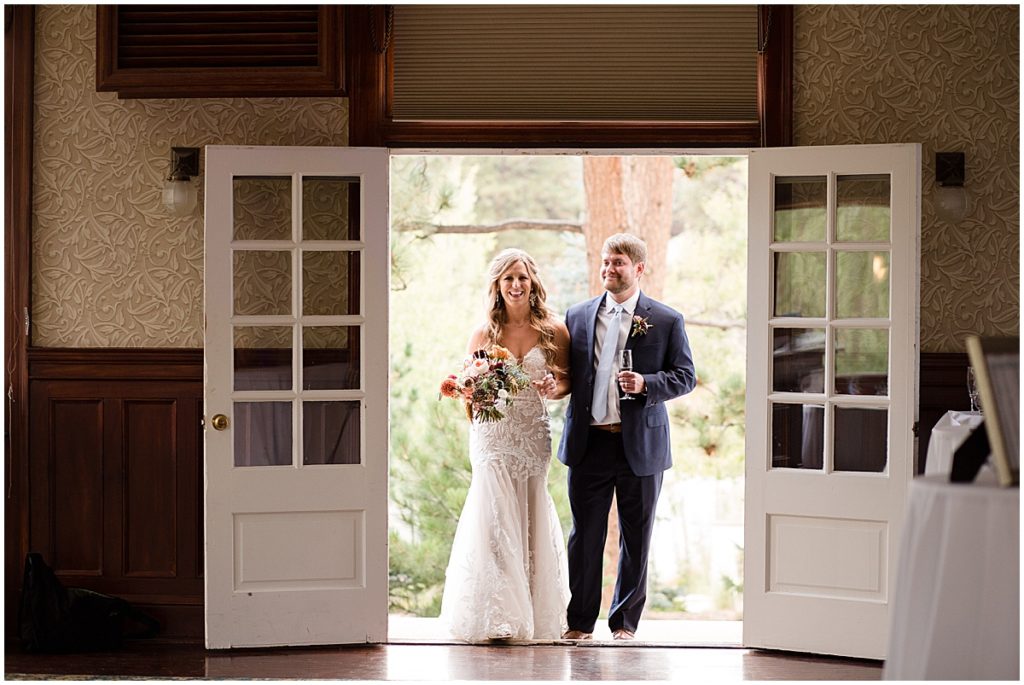 Bride and groom wedding reception at Stanley Hotel in Estes Park.  Bride is wearing dress from Town and Country Bridal holding bouquet from Lace and Lilies Flowers.  Groom wearing suit from Jos A Bank.