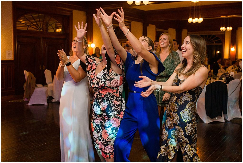 Wedding guests catching bouquet by Lace and Lilies Flowers at the Stanley Hotel in Estes Park.