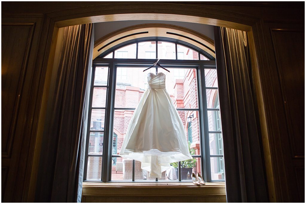 Bride's wedding dress from Bees Bridal hanging at St Regis Hotel in Aspen.