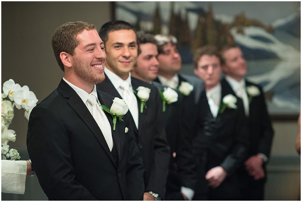 Groomsmen lined up for wedding ceremony at St. Regis hotel in Aspen.