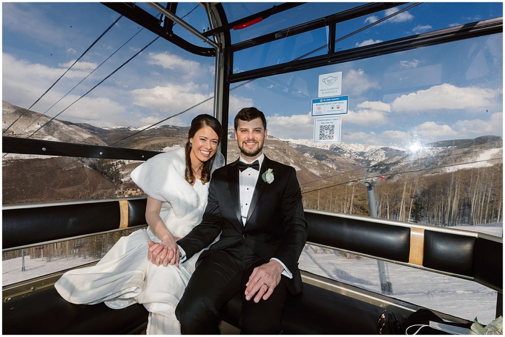 Bride and groom on gondola in Vail.