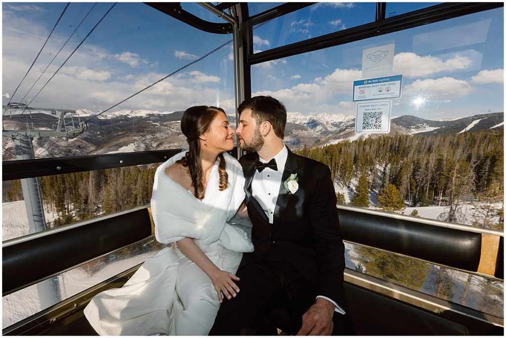 Bride and groom on gondola in Vail.