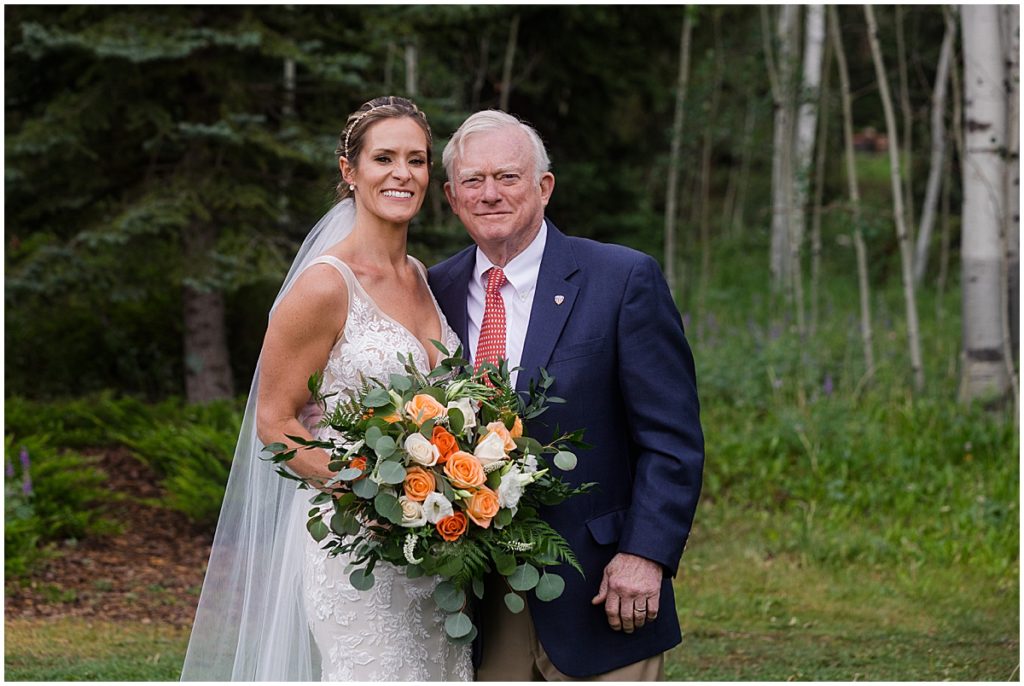 Bride with bouquet designed by Veldkamps after wedding ceremony at Donovan Pavilion in Vail.