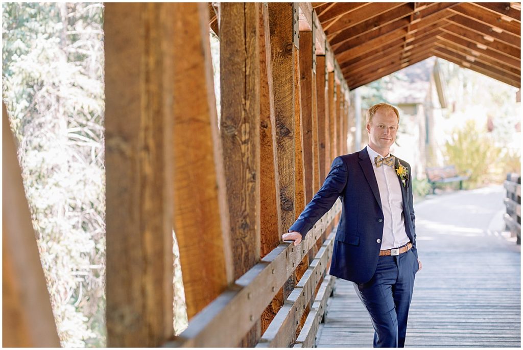 Groom first look wearing suit from The Suit Shop for wedding in Vail.