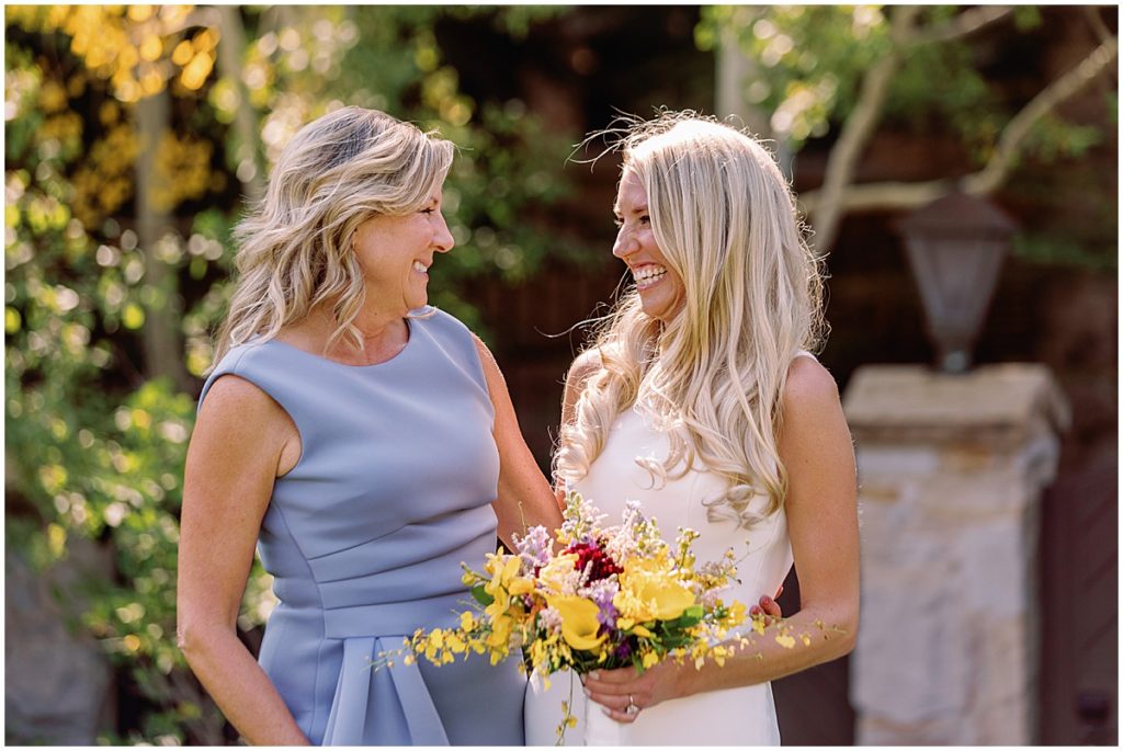 Mother and bride first look before wedding in Vail.  Bride holding bouquet designed by CVB Studio.  Bouquet designed by Studio CVB.  Bride wearing dress from Annika Bridal.