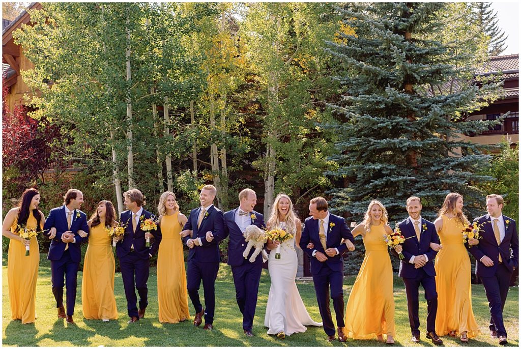 Bridal party outside of Larkspur Vail for wedding.  Bride holding bouquet designed by CVB Studio.